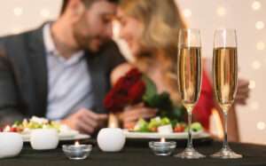 Valentine's Day Celebration Background. Romantic Couple Having Dinner In Restaurant