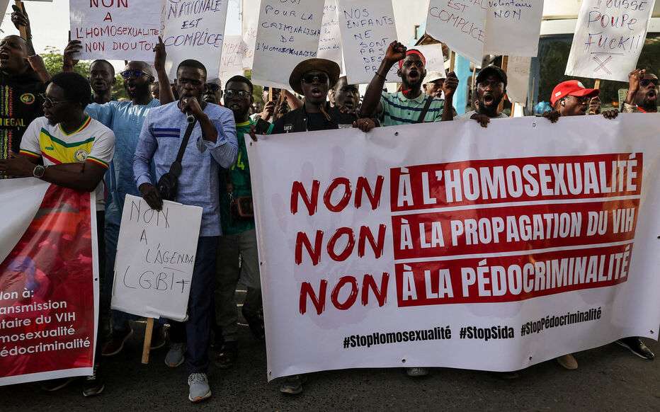 FILE PHOTO: Anti-LGBT demonstrators march through the streets during a protest calling for tougher action in Dakar